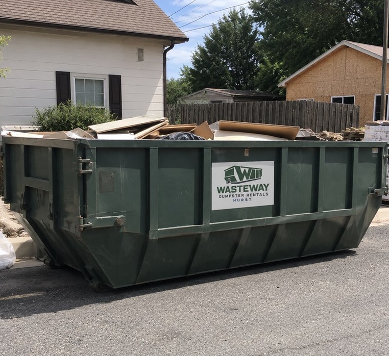 Green Wasteway roll-off dumpster delivered to a driveway